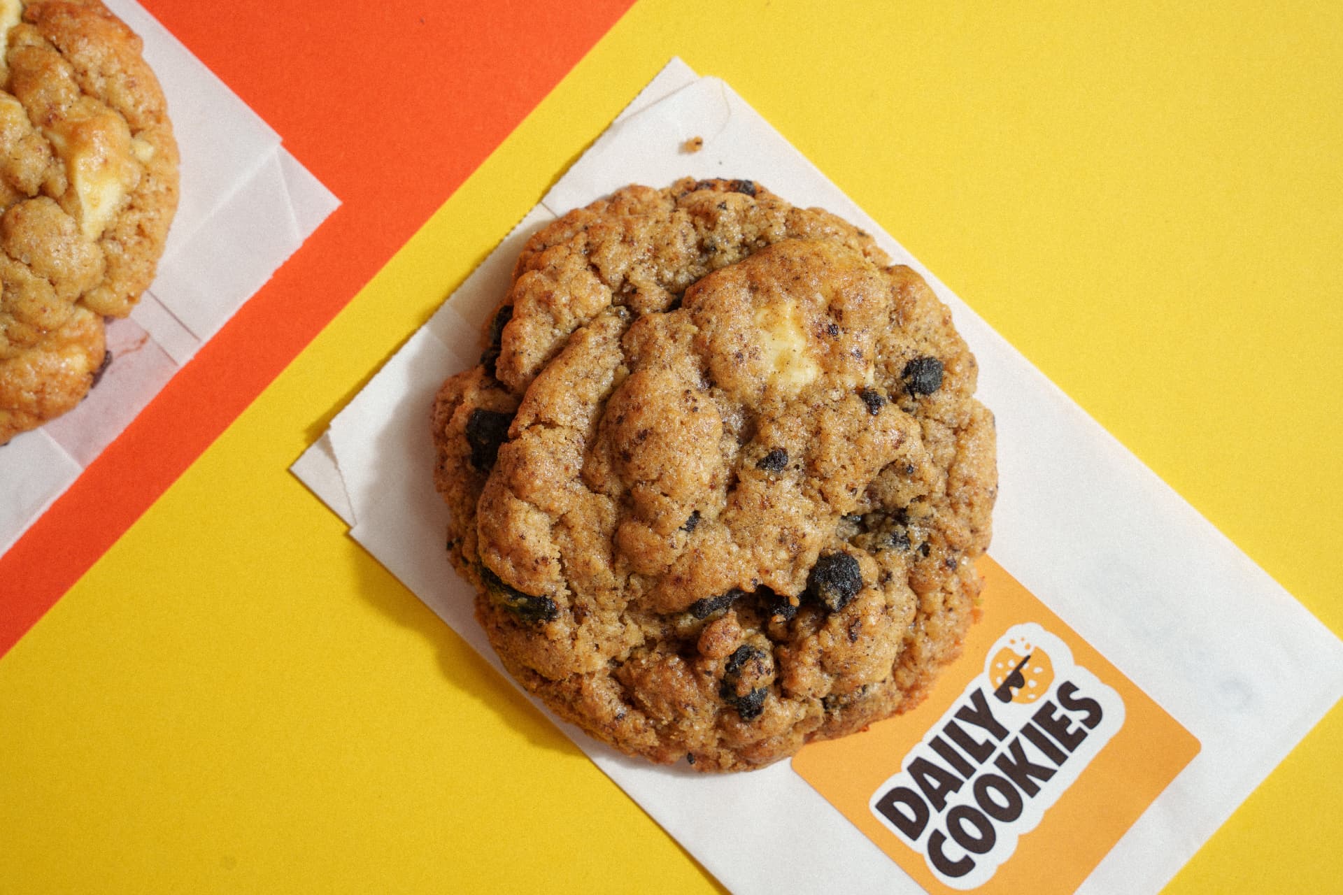 Fresh Daily Cookie on a branded sleeve over yellow